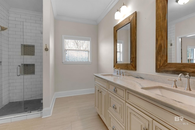 bathroom with an enclosed shower, ornamental molding, and vanity