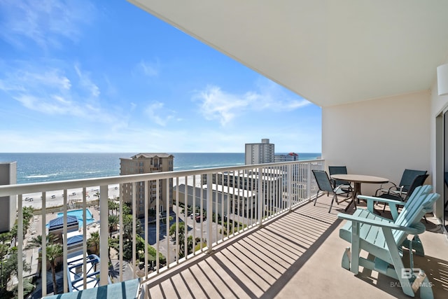 balcony with a water view and a beach view