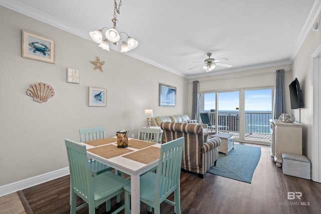 dining area with crown molding, ceiling fan with notable chandelier, and dark hardwood / wood-style flooring