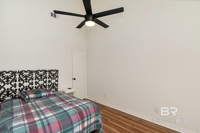 bedroom featuring dark hardwood / wood-style flooring and ceiling fan