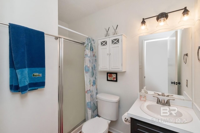 bathroom featuring vanity, a shower with shower curtain, and toilet