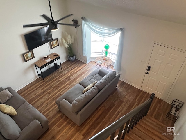 living room featuring dark hardwood / wood-style flooring, ceiling fan, and lofted ceiling