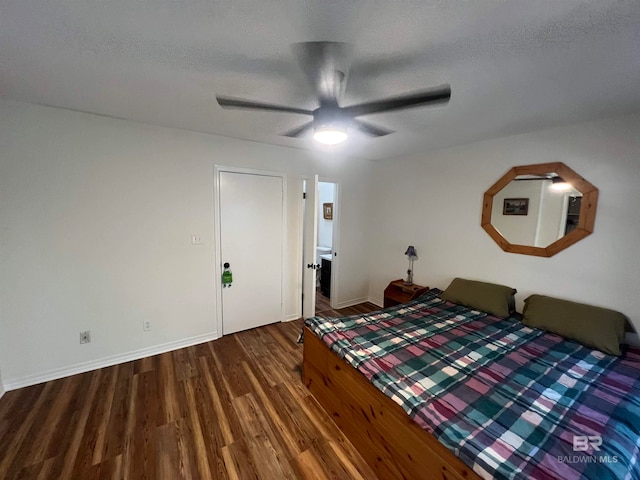 unfurnished bedroom with a textured ceiling, ceiling fan, and dark hardwood / wood-style floors