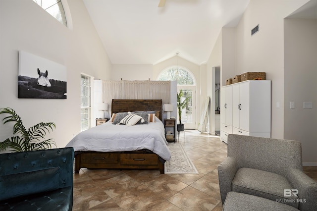 bedroom with visible vents and high vaulted ceiling