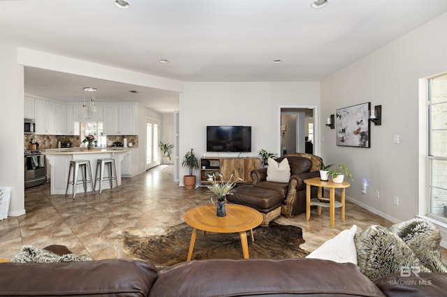 living area with recessed lighting and baseboards