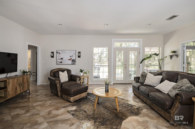 living area featuring recessed lighting, visible vents, and french doors