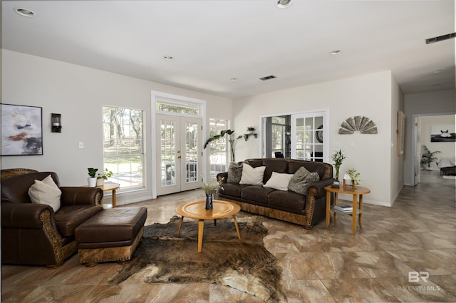 living area featuring recessed lighting, visible vents, and french doors