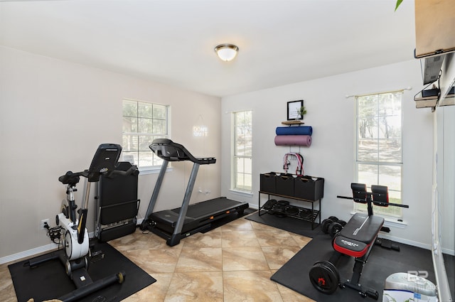 workout room with tile patterned floors and baseboards