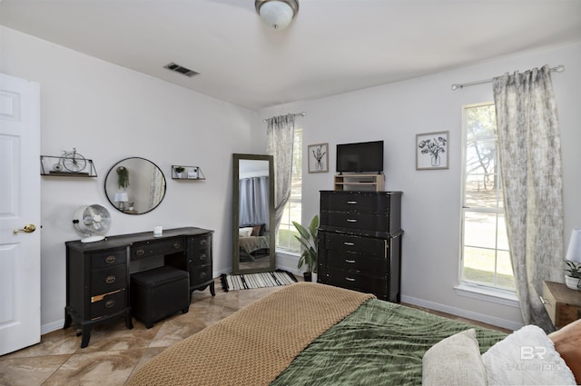 bedroom with visible vents and baseboards