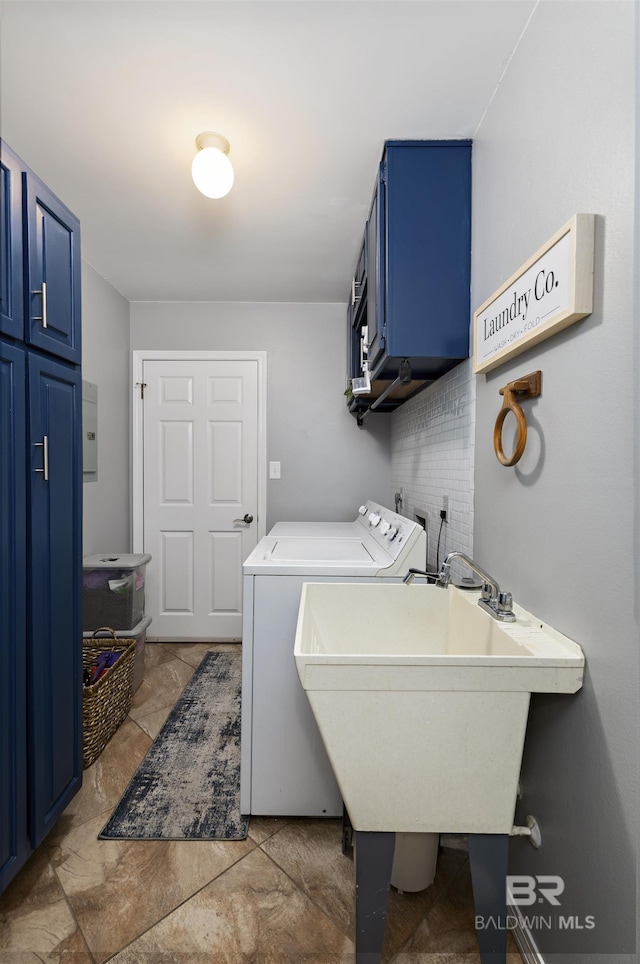 laundry area with washer and dryer, cabinet space, and a sink