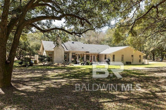 back of property with a patio area and a chimney