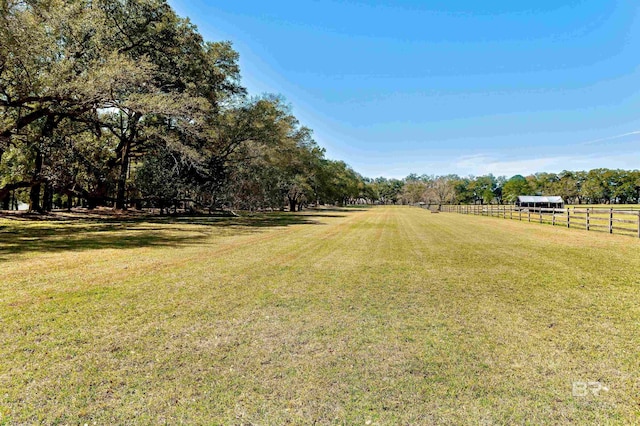view of yard featuring a rural view and fence