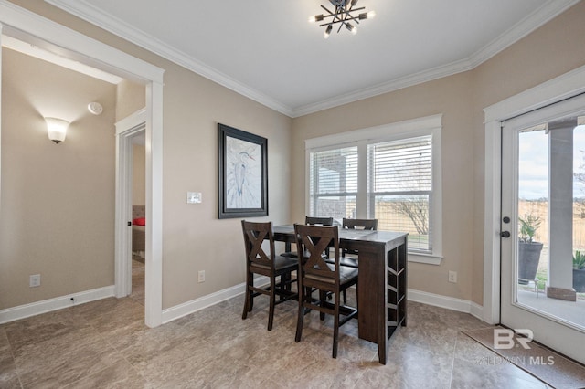 dining area with crown molding and a notable chandelier