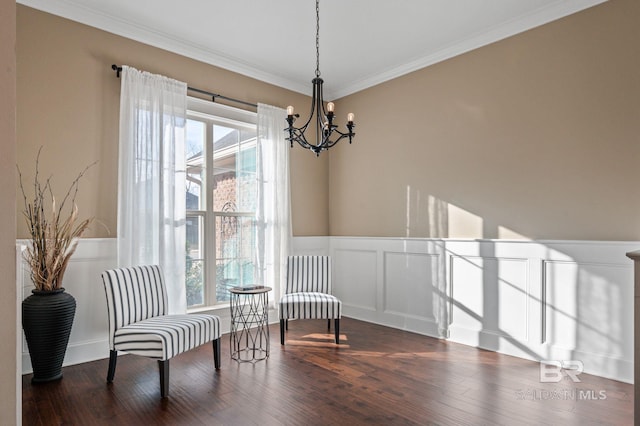 living area with ornamental molding, dark hardwood / wood-style flooring, and a notable chandelier