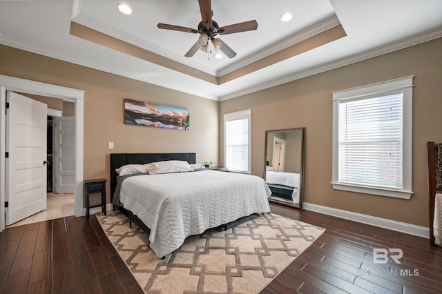 bedroom featuring dark hardwood / wood-style flooring, crown molding, a raised ceiling, and ceiling fan