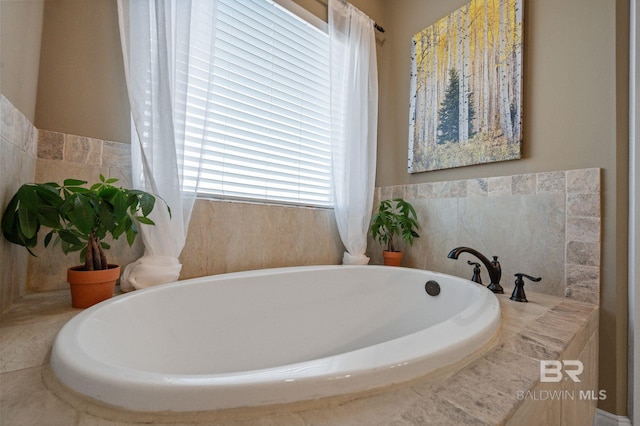 bathroom with a relaxing tiled tub