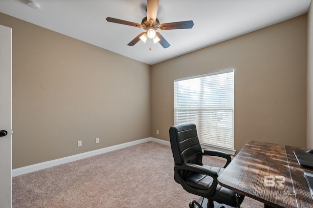 carpeted office space with ceiling fan