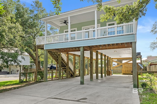 view of front of property with covered porch, a carport, and ceiling fan