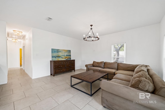 living room with light tile patterned floors and a chandelier