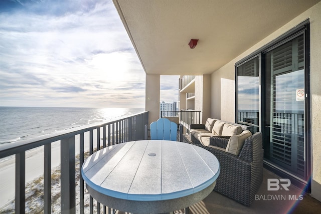 balcony featuring a beach view and a water view