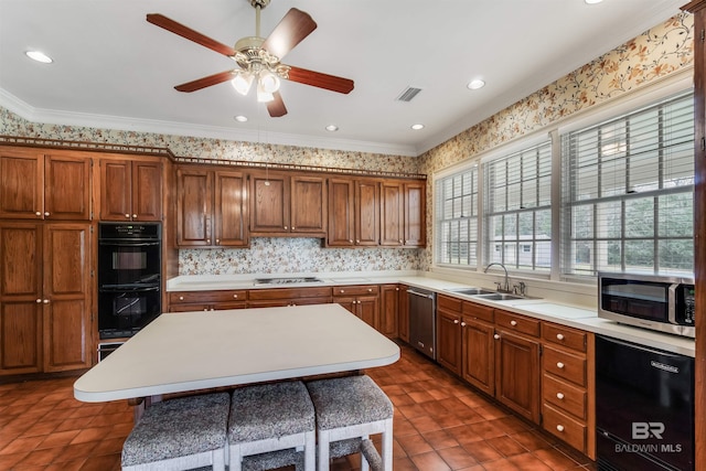 kitchen featuring appliances with stainless steel finishes, light countertops, and a sink