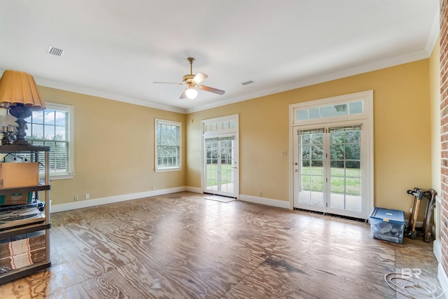 unfurnished living room featuring baseboards, visible vents, ceiling fan, and ornamental molding