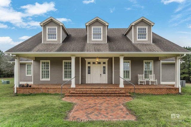 cape cod home with covered porch, central AC, a shingled roof, and a front yard