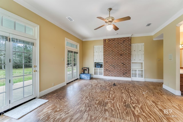 unfurnished living room with crown molding, plenty of natural light, and baseboards