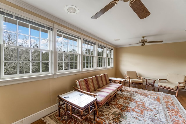 sunroom / solarium with a ceiling fan