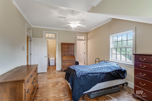 bedroom with visible vents, light wood-style flooring, ornamental molding, a ceiling fan, and baseboards