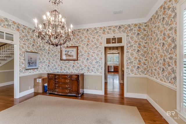 interior space featuring wallpapered walls, visible vents, wood finished floors, baseboards, and stairs
