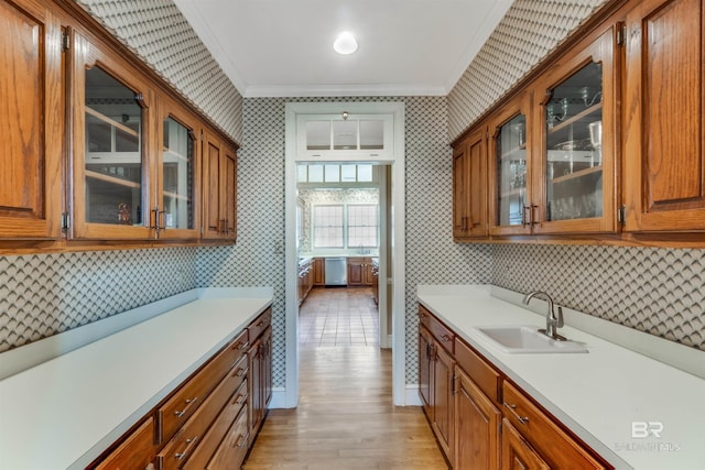kitchen with wallpapered walls, glass insert cabinets, and light countertops