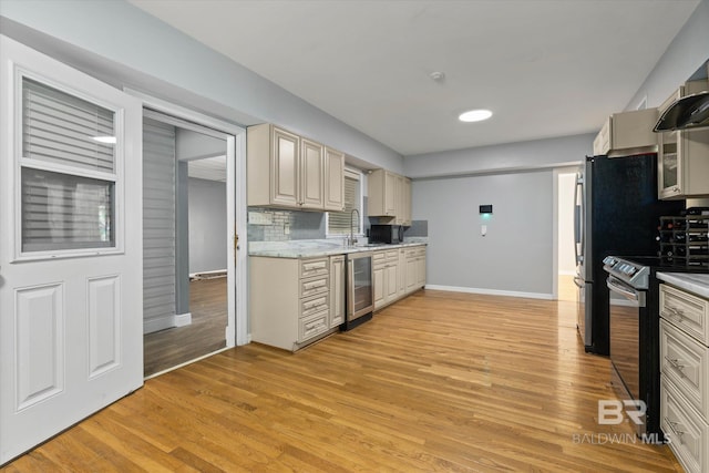 42 W Lourando Dr, Mobile, AL 36606 - kitchen featuring stainless steel electric stove, beverage cooler, light wood-style flooring, and decorative backsplash