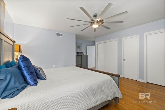 42 W Lourando Dr, Mobile, AL 36606 - bedroom featuring two closets, wood finished floors, and a ceiling fan