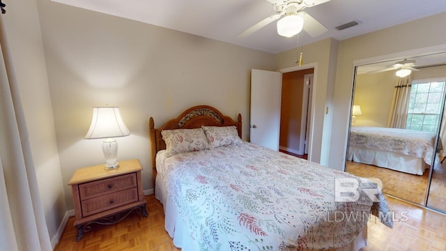 bedroom with a closet, light parquet floors, and ceiling fan