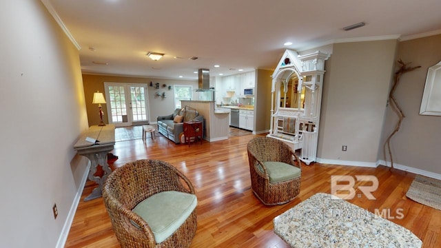 living room with french doors, light hardwood / wood-style flooring, and crown molding