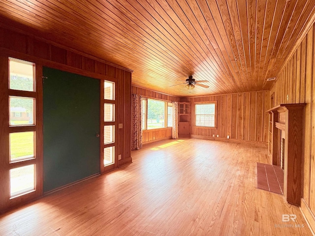 613 S Carney St, Atmore, AL 36502 - unfurnished living room featuring wood ceiling, wooden walls, ceiling fan, healthy amount of natural light, and light wood-style flooring