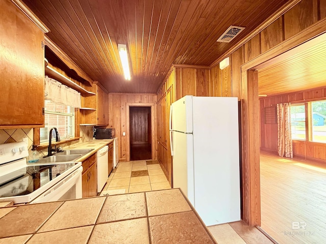 613 S Carney St, Atmore, AL 36502 - kitchen with white appliances, wood ceiling, wood walls, and open shelves