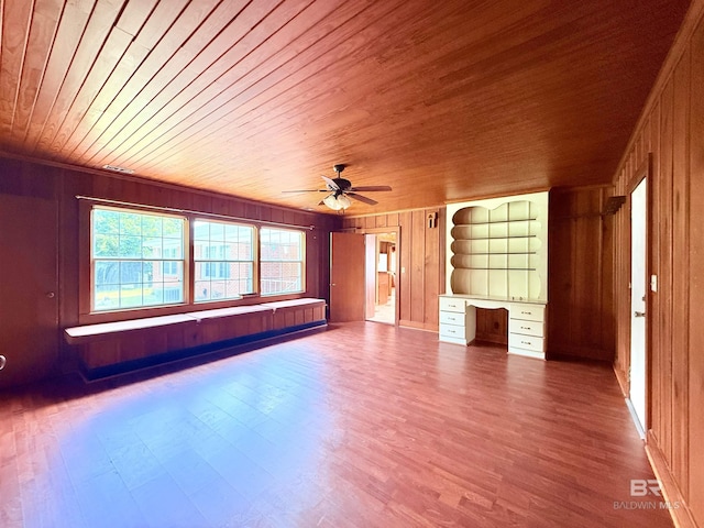 613 S Carney St, Atmore, AL 36502 - unfurnished living room with wooden walls, wooden ceiling, wood finished floors, a ceiling fan, and crown molding