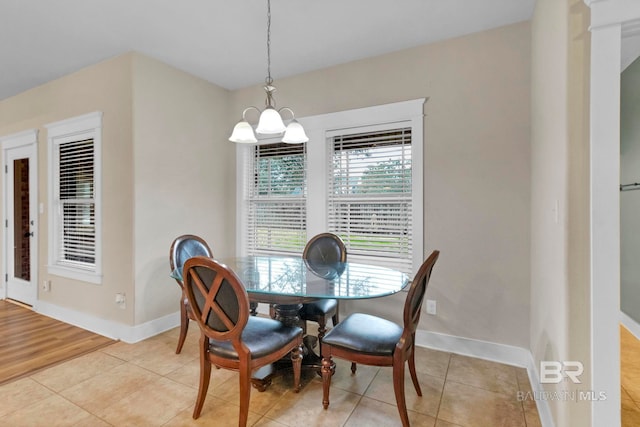 dining area with an inviting chandelier and light tile patterned floors