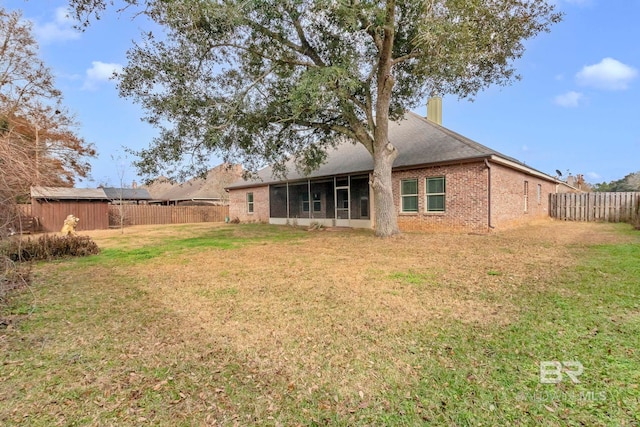 back of house with a lawn