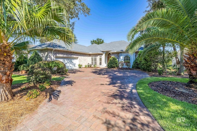 331 Peninsula Blvd, Gulf Shores, AL 36542 - ranch-style home with decorative driveway and an attached garage