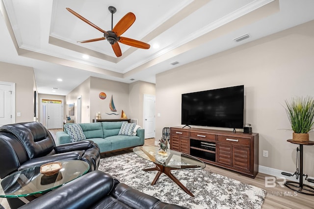 26635 Terry Cove Dr, Orange Beach, AL 36561 - living area featuring visible vents, baseboards, light wood-type flooring, a raised ceiling, and crown molding