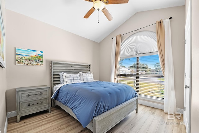 26635 Terry Cove Dr, Orange Beach, AL 36561 - bedroom featuring vaulted ceiling, light wood-type flooring, a ceiling fan, and baseboards