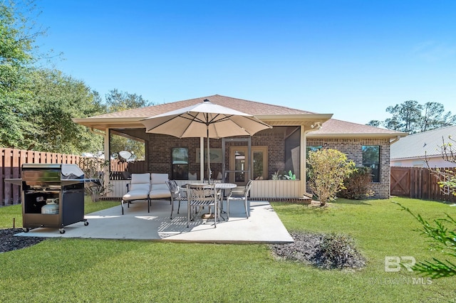 26635 Terry Cove Dr, Orange Beach, AL 36561 - back of property with brick siding, a yard, a patio, roof with shingles, and fence private yard