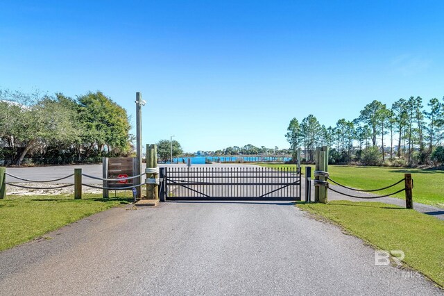 26635 Terry Cove Dr, Orange Beach, AL 36561 - view of gate featuring a lawn