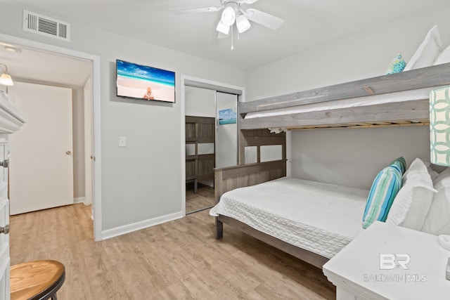 bedroom featuring a closet, visible vents, baseboards, and light wood-style floors