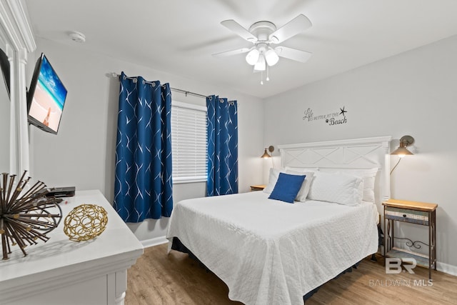 bedroom with wood finished floors, baseboards, and ceiling fan