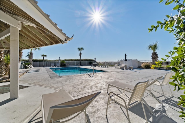 pool featuring a patio and fence