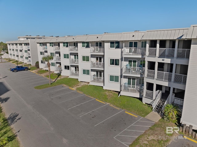 view of building exterior featuring uncovered parking